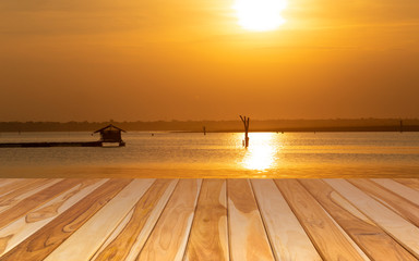 Empty wooden plank on lake during sunset background. Wood board table perspective.
