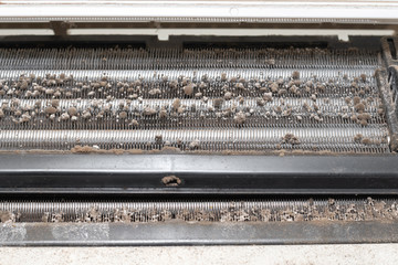 Dirty split air conditioner with dust and fungus. Close-up on a air conditioner that needs cleaning.