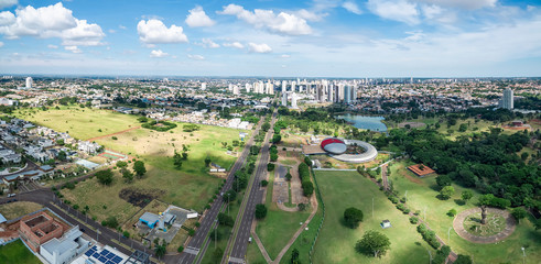 Aerial view of Campo Grande MS, Brazil - Highs of Afonso Pena avenue. Aerial view of a growing city with some buildings and a huge green area. Green city.  - obrazy, fototapety, plakaty