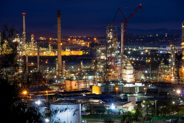 Refinery and industrial natural gas tanks with the backdrop of the morning sky