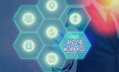 Word writing text And The Winner Is. Business photo showcasing announcing a demonstrating or thing that wins something