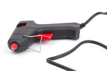 Electric hot glue gun on white background. Rods for glue gun