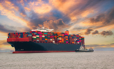 Logistics and container loading by large barges by sea in a harbor full of containers waiting to be...