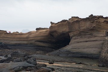 Fototapeta na wymiar a layer of black rock stone near the sea.