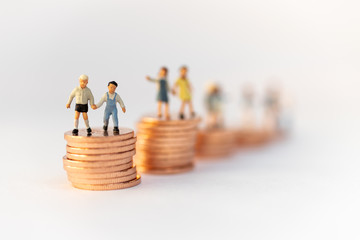 Miniature people: Children standing on top of stacked coins . Image use for background , Life insurance concept, Fund for education