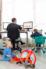 Father with kids working from home during quarantine. Stay at home, work from home concept during...