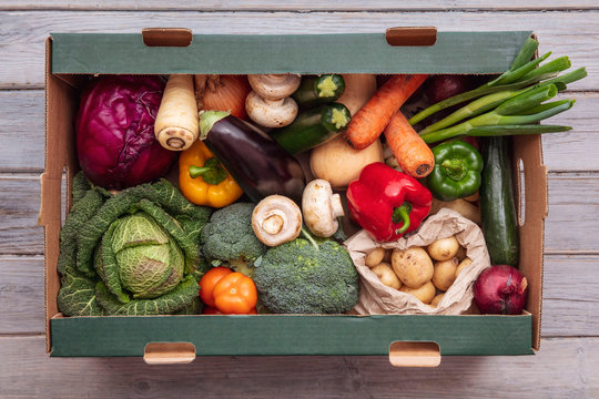 Fresh Organic Vegetable Delivery Box On A Wooden Background