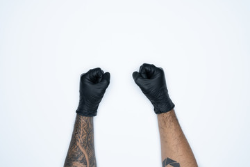 A man hand and gestures in Black rubber glove shows fist scat sign isolated on white background.