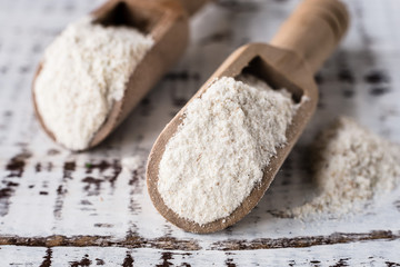 Cassava (yuca) flour in wooden spoons, macro photo, close-up