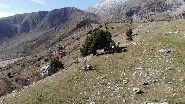 2 person hiking in high altitude with mountain and valley in the background