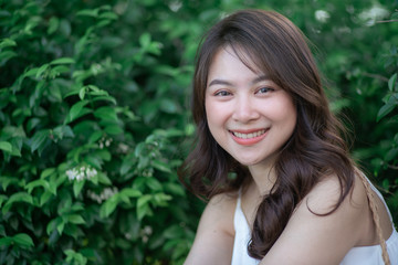 Naklejka premium Beautiful smiling happy young asian woman recreation day sun light background