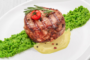steak mignon with pea puree and cream sauce