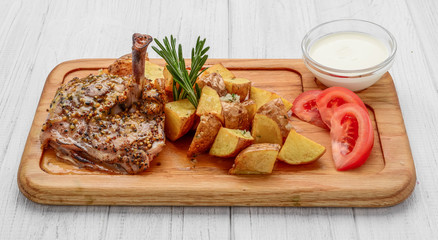Grilled chicken with potatoes on the plate