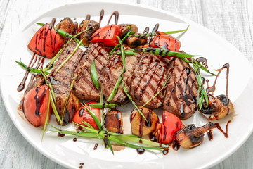 Grilled beef steak with mushrooms and tomatoes. Concept for healthy nutrition.