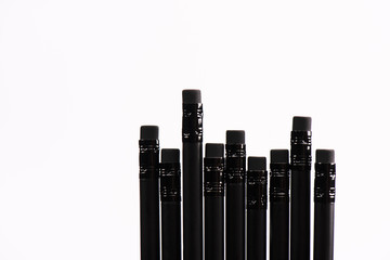 top view of black pencils with erasers isolated on white