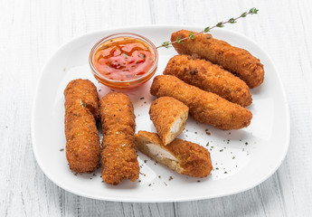 Fried chicken nuggets with ketchup on a plate