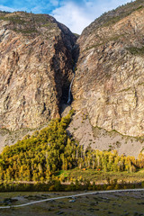 Waterfall in a mountain gorge. The confluence of the Karasu River into the Chulyshman River....