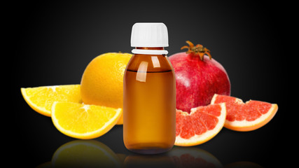 Fresh and ripe fruits, orange, grapefruit and pomegranate with medical bottle.