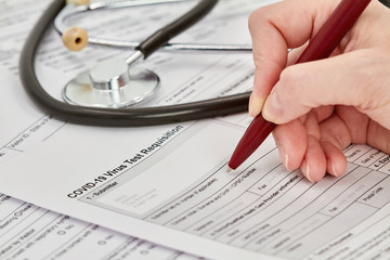 Doctor is getting ready to fill out a Virus test Requisition form. Stethoscope on the background. Closeup. © marketlan