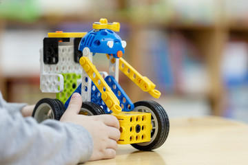 plastic toys are on the table of the car.educational toy constructor stands on a table in a kindergarten or at home