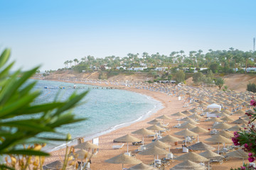 The sea coast is closed to tourists for quarantine. Resort coast without people . The concept of the collapse of the tourism industry. An empty beach with many sun loungers and umbrellas. © Климов Максим