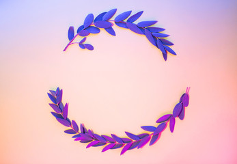 Fototapeta na wymiar Light neon background with leaves. Glowing abstract backdrop with plants frame and space for your text. Exotic nature branch with blue and purple vivid colors. Summer twigs with shiny illumination