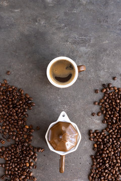 Espresso with foam, coffee maker and coffee grain on brown concrete backgoun. © vasanty