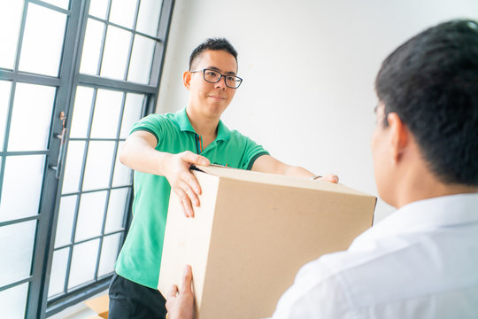 Smart Green Shirt Delivery Man Delivery Of Boxes To Business Office Man