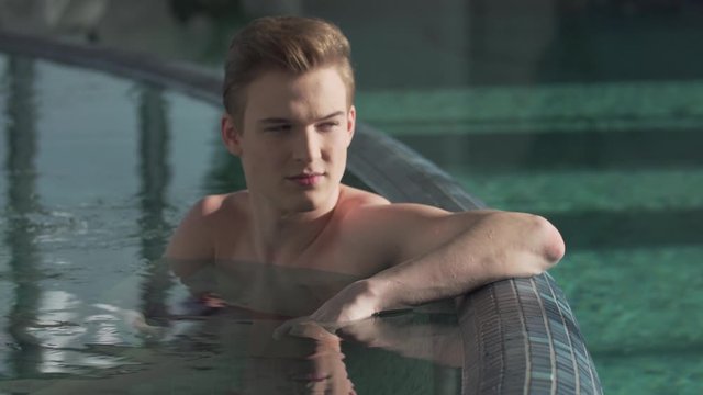 handsome guy resting in the pool
