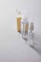 hand sanitizer in spray bottles and antibacterial soap on white background