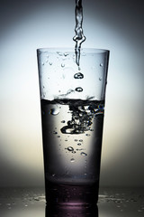 Drink water pouring in to glass . Close up. Vertical shot