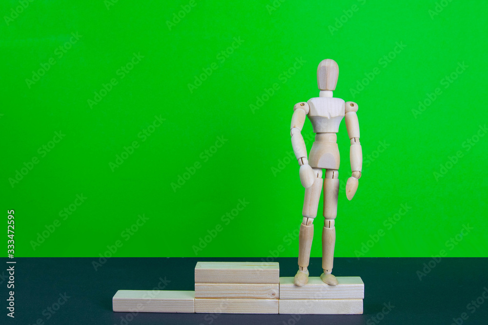 Wall mural full length portrait of male winner on winner's pedestal, on green background. the composition of 3 