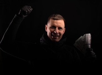 Man in black hoody with american dollar money