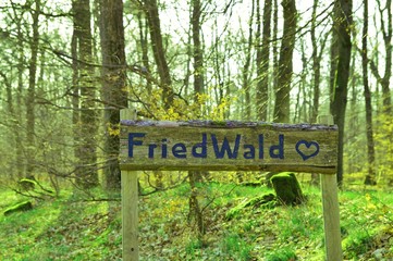 sign in german language, text Friedwald- forest cemetery. natural funerals in woodland, Natural...