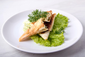 Pita triangles with cottage cheese, herbs, on a white plate