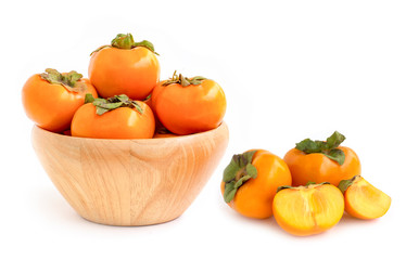 Persimmons fruit in wooden bowl isolated on white background.