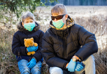 Boys in protective sterile medical mask.