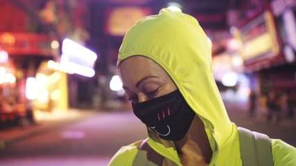 Woman close up look caucasian at Pattaya Walking Street with wearing protective medical mask. Lockdown quarantine isolation. Health virus protection coronavirus epidemic sars-cov-2 covid-19 2019-ncov.