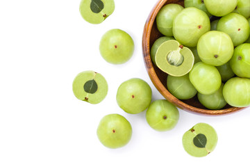 Indian gooseberry fruits ( Amla, phyllanthus emblica ) in wooden bowl isolated on white background. Top view. 