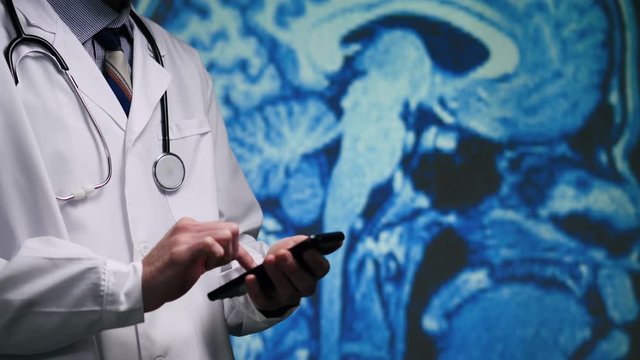 Doctor in a white lab coat with a stethoscope checking a brain MRI SCAN .Public Domain background element from U.S. Centers for Disease Control and Prevention