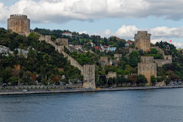 Fototapeta na wymiar The thick Stone walls and Towers of the Rumeli Fortress at the narrowest point of the Bosphorus Straits in Istanbul.