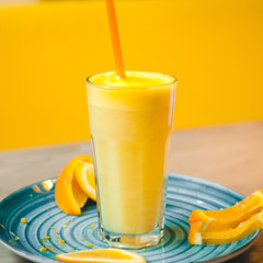 Orange juice in glass with fresh fruits on wooden table