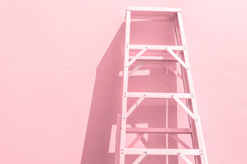 Ladder on pink background.