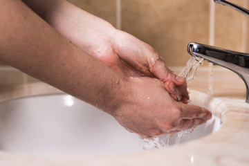woman washing hands in bathroom