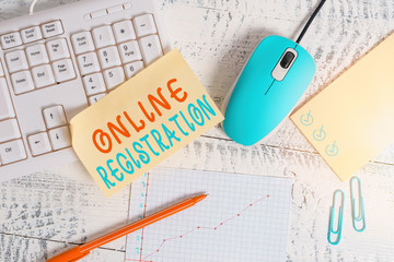 Conceptual hand writing showing Online Registration. Concept meaning System for subscribing or registering via the Internet Writing equipments and computer stuff placed on wooden table