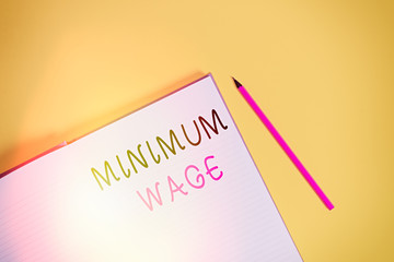Text sign showing Minimum Wage. Business photo text the lowest wage permitted by law or by a...