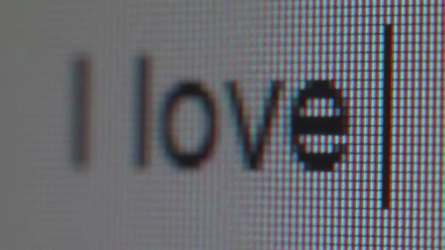 Typing of phrase i love you. Close up view.