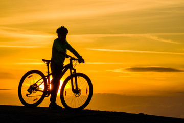 Obraz na płótnie Canvas Silhouette of young mountainbike cyclist at sunset, Sweden
