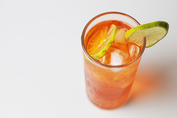Iced tea lemon juice fresh drink on white bakcground, Isolate black tea and lime lemon in the glass cocktail drink.