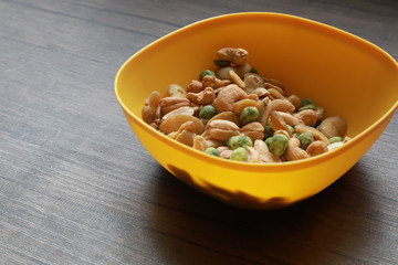 Mixed snack nuts, cashew, almonds, green nuts in the little bowl put on wood tray. snack food for coffee break 